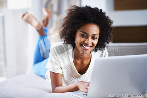 Image of Smile, relax and woman with a laptop, typing and connection for movies, social media and online reading. Female person, happy lady and girl with happiness, technology and chatting at home