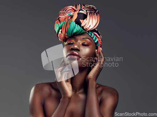 Image of Beauty, makeup and black woman with a turban in studio with a elegant, glam and cosmetic face. Beautiful, young and African female model with a head wrap with sensual pose isolated by gray background