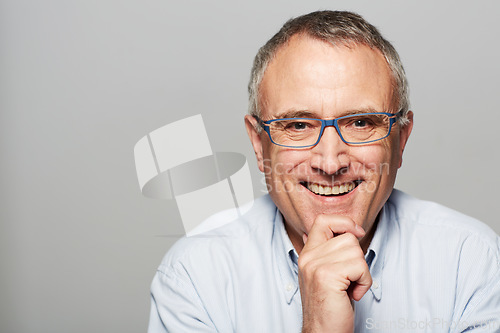 Image of Senior man, portrait and smile in studio with happiness, pride and confident by gray background. Elderly guy, happy and excited face for experience, knowledge and retirement by backdrop with glasses