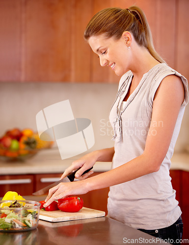 Image of Woman, cooking and knife for pepper with smile, vegetables or nutrition in home kitchen for healthy meal. Girl, cutting vegetable or happy for food, lunch or dinner in house with diet for wellness