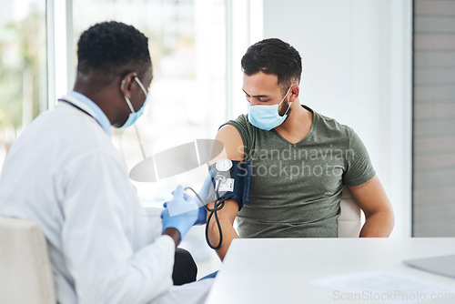 Image of Covid, mask and doctor test blood pressure of patient in a hospital or cardiology exam by medical worker in a clinic. Hypertension, help and professional healthcare employee consulting man for corona