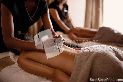 Image of Hands, back massage and woman in spa with luxury service for muscle, body and relax with peace in resort. Masseuse, hospitality and physical therapy on bed for wellness, zen and healing in salon