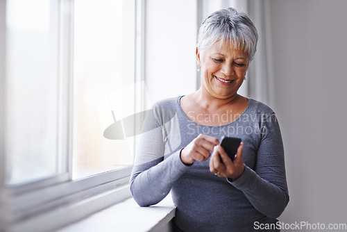 Image of Window, app and senior woman with a smartphone, connection and typing for social media at home. Mature lady, female person and model with a cellphone, communication and online reading with texting