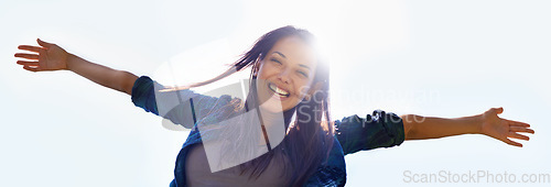 Image of Portrait, sky and open arms with a woman outdoor in nature to celebrate a life of financial freedom in summer from below. Smile, banner and wellness with a happy young female person with lens flare