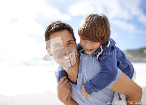 Image of Father, child or family at beach for portrait, travel or holiday in summer with a smile for piggy back fun. A man and kid or son playing together on vacation at sea with a blue sky and happiness