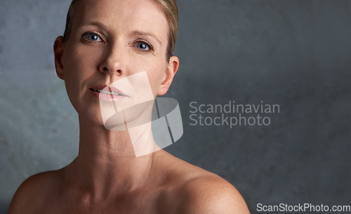 Image of Mature woman, skin care and portrait with natural beauty and cosmetic dermatology. Isolated, gray background and female person face with facial treatment and mock up with anti aging cosmetics