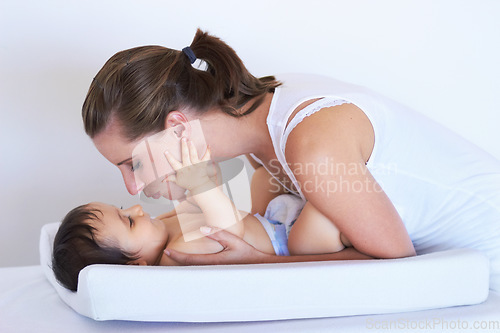 Image of Mother, smile and baby kiss at home on diaper changing table with happiness. Family, house and young child with mom feeling love, care and parent support from bonding together with cute kid and mama