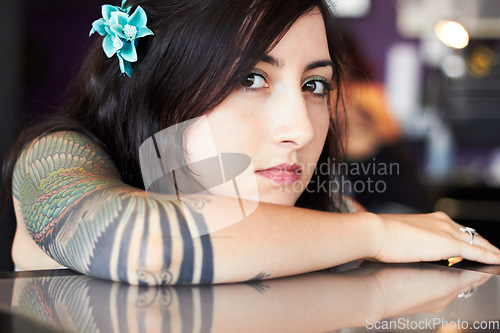 Image of Beauty, tattoo and portrait of woman in parlor for body art, design and creativity in ink shop. Face, artist and serious female person with flower in hair with cosmetics, natural beauty and tattoos