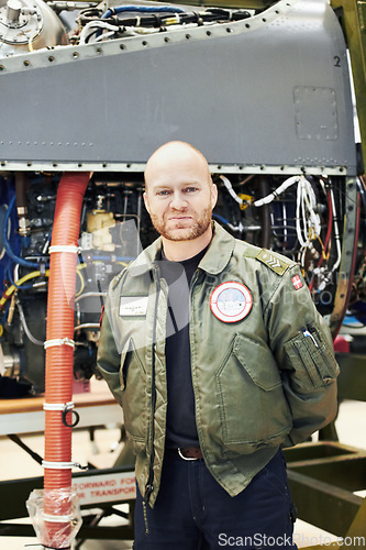 Image of Portrait, pilot and military engine or male aircraft engineer in uniform and plane in hangar. Airplane, maintenance and officer gear or man mechanic in front aircraft for repairs or army and tarmac