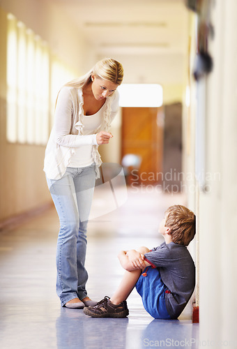 Image of Teacher, school and scolding child student for bad behaviour, problem or learning lesson. Frustrated woman pointing to punish boy for discipline, pedagogy or fail in education building hallway