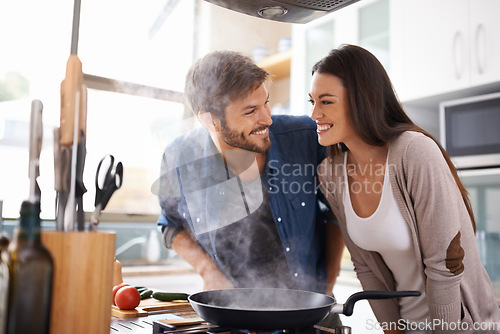 Image of Food, love and happy couple in kitchen cooking, smile and preparing lunch in their home together. Dinner, date and man with woman excited, hungry and cheerful for meal preparation in their apartment