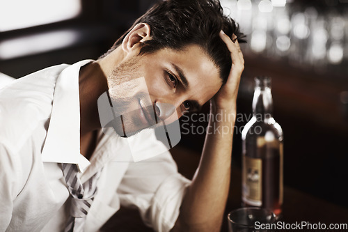 Image of Bar counter relax man and portrait of happy hour with alcohol and whiskey after work. Bottle, young male person and hand in hair in a restaurant with a playboy guy with a glass and confidence in pub