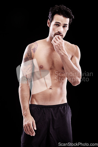 Image of Portrait of strong man, fitness and abs on black background, studio and sexy six pack. Muscular bodybuilder, male model and topless sports athlete with tattoo, muscle and power for exercise training