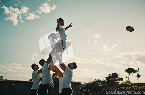 Image of Rugby, team jump and lift for ball and teamwork, sport and training for game, fitness and exercise or sports performance with blue sky. Group, men and lifting man to catch and professional match