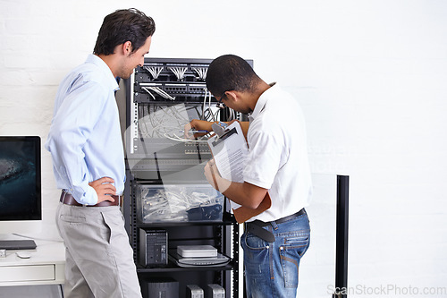 Image of Server room, man or electrician with working on hardware maintenance after glitch in business office. Network, clipboard or worker with a technician or electrical engineer for information technology