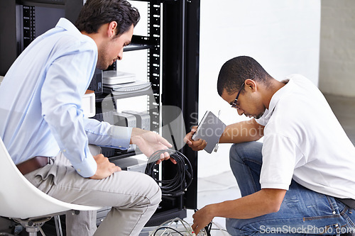 Image of Server room, man or technician fixing electronics for hardware maintenance or working on glitch in office. IT support or worker with an electrician or electrical engineer for information technology