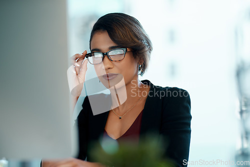 Image of Computer, glasses and business woman reading report, online research or article, news and data analysis. Focused african person or professional worker with website editing or analytics on desktop pc