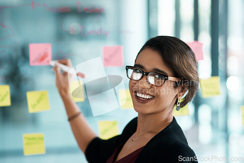 Image of Creative woman, portrait and writing on glass moodboard for ideas, brainstorming workflow or project priority. Business, biracial person with sticky notes and schedule, planning and creative solution