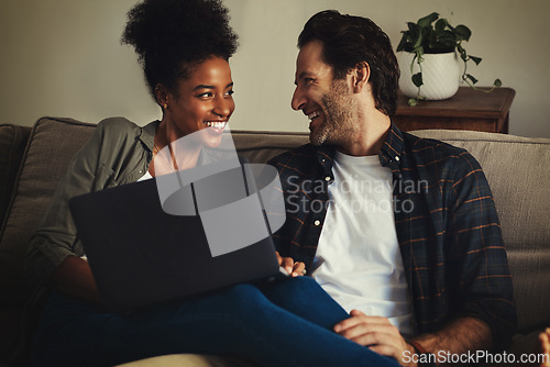 Image of Laptop, entertainment and interracial with a couple streaming a movie using an online subscription service to relax. Computer, watching or internet with a man and woman bonding together over a film
