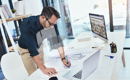 Image of Corporate, man architect with laptop or computer and sketch in office with notebook at his desk at work. Technology, entrepreneur and male person drawing in plan with pc on table in modern workspace