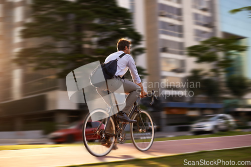 Image of Fast, bicycle and business man in city for morning, commute and carbon neutral transportation. Travel, sustainability and cycling with male employee in urban town for motion blur, speed and transit