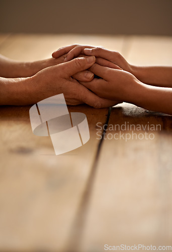 Image of Love, support and closeup of people holding hands for grief, hope and sympathy after loss. Gratitude, empathy and couple having intimate moment with affection for unity, trust and solidarity on table