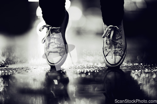 Image of Balance, shoes or fashion in monochrome on an urban street outdoor for dance or contemporary style. Feet, sneakers or footwear in black and white in a city to explore for travel, tourism or adventure