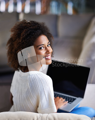 Image of Portrait, smile and woman on a couch, laptop and connection for social media, happiness and relax at home. Face, female person and happy girl on a sofa, technology and search website for information