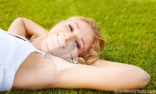 Image of Portrait, relax and a woman lying on grass outdoor in nature during summer for peace or quiet on a field. Spring, garden and freedom with a young person relaxing outside on countryside green ground