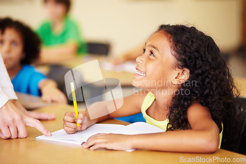 Image of Teaching, child writing and hand of teacher helping student at school for education, learning or development. Woman with happy girl for notebook, pencil and knowledge at classroom desk with support