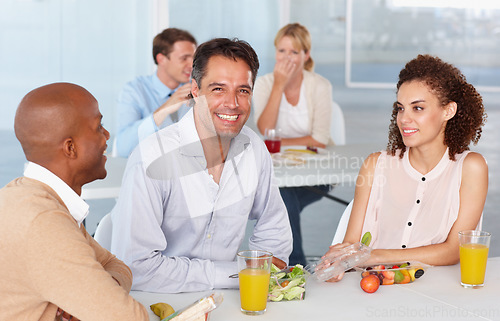 Image of Portrait, lunch and a happy business team eating food during their break in the office at work. Diversity, friends or colleagues with a man and woman employee group enjoying a meal in the cafeteria