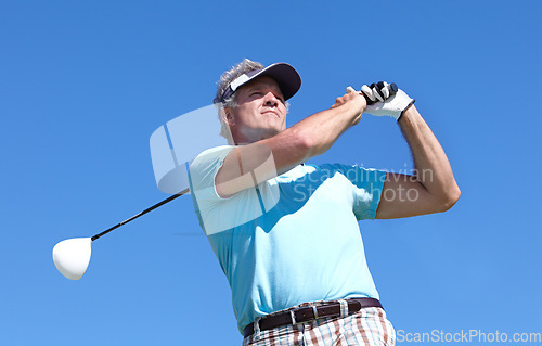 Image of Golf, swing and elderly man with driver outdoor for training, hobby and sports on blue sky background. Club, swinging and active senior male golfer on field for retirement fitness, match or practice