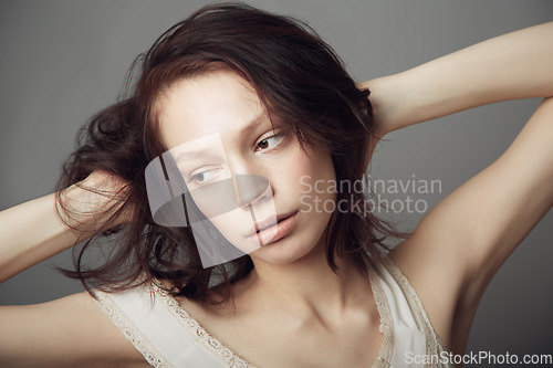 Image of Sad, thinking and a woman with mental health problem isolated on a dark background in a studio. Idea, depression and a young girl or model with ideas, depressed and thoughts of anxiety on a backdrop