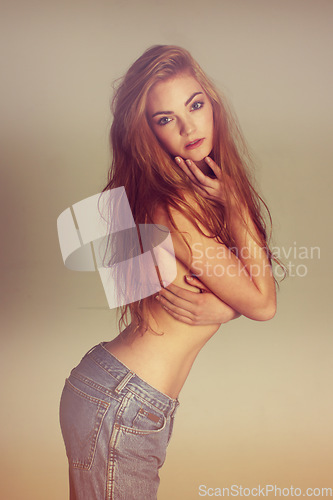 Image of Portrait, fashion and shirtless sexy woman in jeans with long hair on studio background with designer clothes. Art, aesthetic beauty and model or influencer in luxury makeup or retro blue denim style