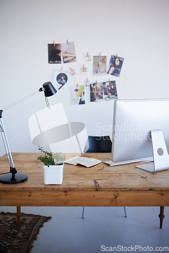 Image of Empty office, computer desk and small business startup of interior or online marketing studio. Photo wall with desktop PC and notebook with lamp on table for creativity in a clean modern workspace