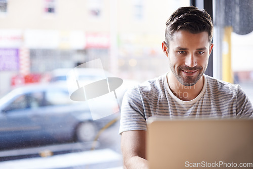 Image of Entrepreneur, smile and man with a laptop, cafe or typing for information, project or review. Male employee, freelancer or happy worker with connection, technology and search website at a coffee shop