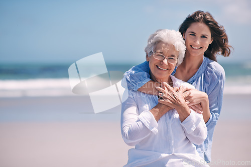 Image of Portrait, beach and young woman with her senior mother embrace and smile together outdoors on mockup. Family, happy and hugging elderly lady with adult daughter or at the ocean or sea for travel