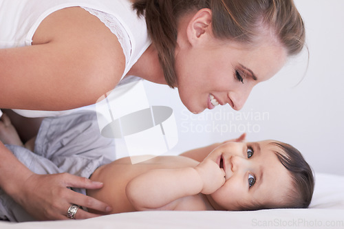 Image of Mother, happy and baby smile at home on diaper changing table with happiness. Family, house and young child with mom feeling love, care and parent support from bonding together with cute kid and mama