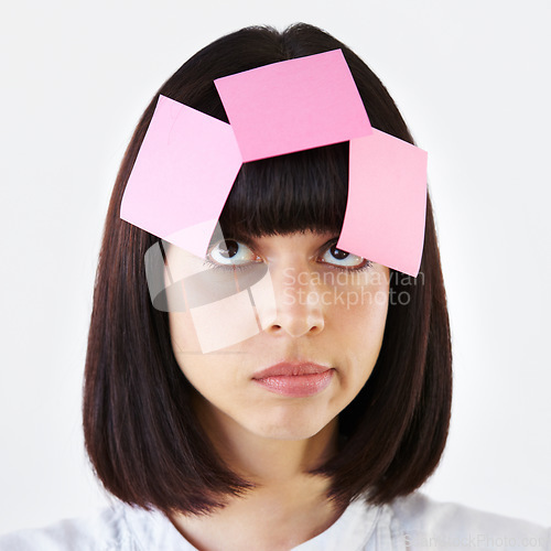 Image of Sticky notes on face of woman thinking in studio with planning, daydreaming or idea. Wonder, contemplating and pensive female model with paper on her head for solution isolated by a white background.