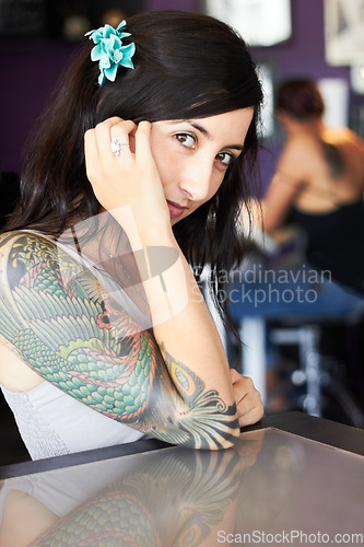 Image of Creative, tattoo and portrait of woman in parlor for body art, design and creativity in ink shop. Tattoos, artist and face of female person with flower in hair for natural beauty, cosmetics and smile