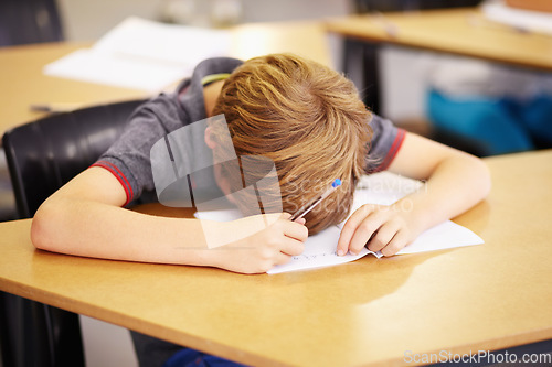 Image of Sleeping, bored and tired with boy in classroom for learning, education and knowledge. Stress, anxiety or confused with male student at desk in school adhd for exhausted, autism problem or frustrated