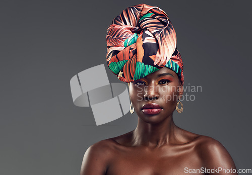 Image of Portrait, head wrap and black woman with fashion, beauty and confident on a grey studio background. Face, female person and model with traditional turban, cosmetics and makeup with skincare or mockup