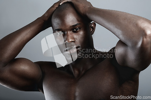 Image of Art, aesthetic and beauty, portrait of black man on dark background with muscle and hands on head. Health, wellness and sexy African bodybuilder or male model isolated on studio backdrop with power.