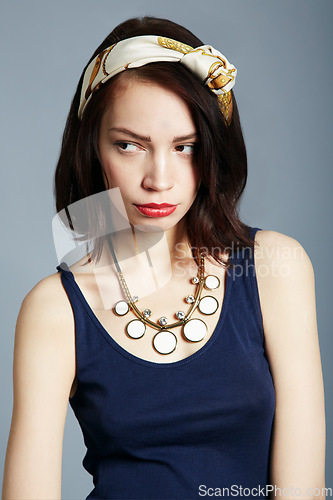 Image of Face, woman in vintage fashion with attitude or moody, frown or frustrated pose on studio background. Model, girl and upset or tired expression in retro clothing and style, magazine or beauty