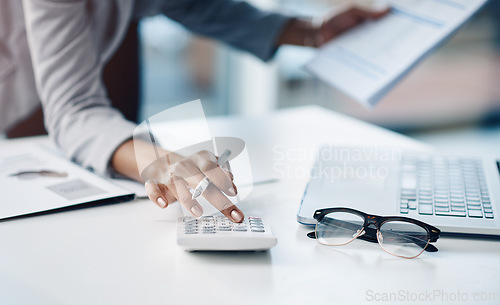 Image of Calculator, hand and female accountant working on finance investment report in the office. Accounting, taxes and closeup of woman financial advisor doing calculation for asset management in workplace