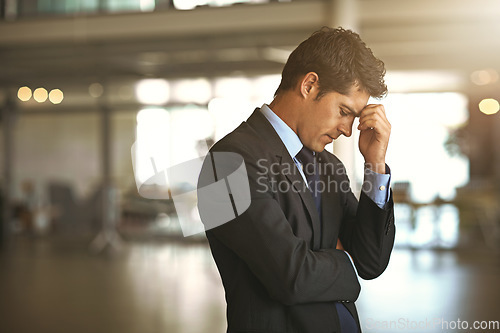 Image of Headache, stress businessman standing and at his office sad or upset at debt fail at work. Mental health or anxiety, burnout and exhausted or depressed male corporate worker frustrated and tired