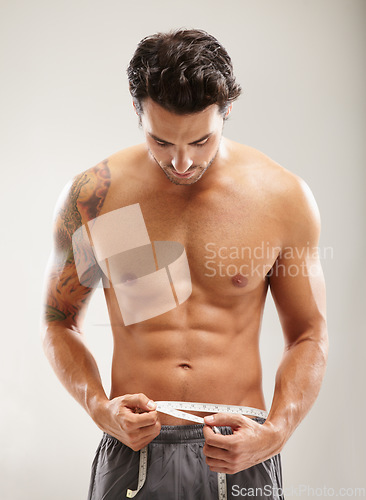 Image of Abs, healthy or man with tape measure for fitness after body workout isolated on white background. Male model, six pack goal or sexy athlete after stomach muscle exercise or training to lose weight