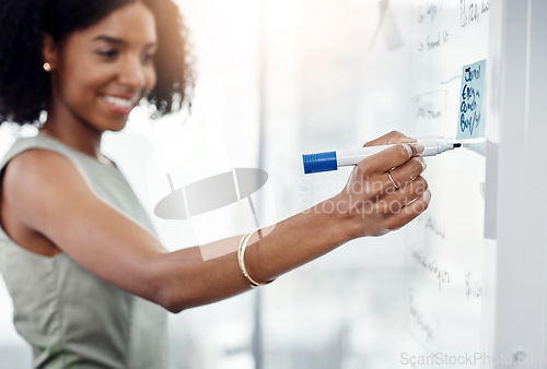 Image of Business, glass wall and black woman writing, brainstorming or strategy in office. Planning, board and happy female person write, working on project and schedule, sticky note or info in workplace.