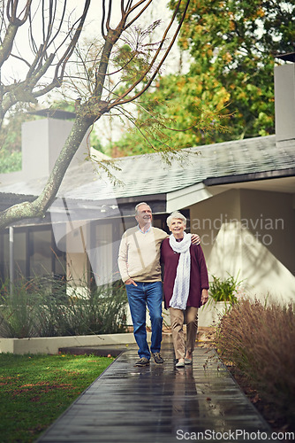 Image of Love, outdoor and elderly couple walking by their house for wellness, fresh air and bonding. Happy, retirement and senior man and woman on a path together in their garden at their modern home.