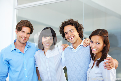 Image of Business people, portrait smile and hug in teamwork for friendship, team building or success at the office. Happy and confident employees standing together smiling for company goals at workplace